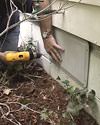 A crawl space vent being sealed by our vent covers