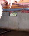 Tennessee crawl space with vents, showing mold, rot, and fiberglass insulation dripping off the ceiling.