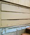 an old-fashioned crawl space door in Irving College about to be replaced